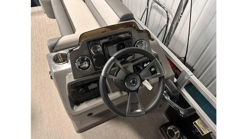 Slide: The Image of 2025 Tahoe Pontoon Sport 85 Rear Fish dashboard with steering wheel and controls. - 10