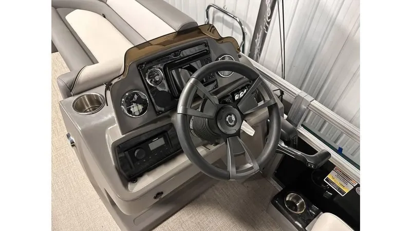 Slide: The Image of 2025 Tahoe Pontoon Sport 85 Rear Fish dashboard with steering wheel and controls. - 12