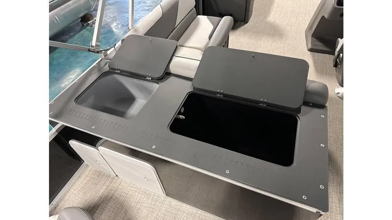 Slide: The Image of 2025 Tahoe Pontoon Sport 85 Rear Fish boat interior with storage compartments open. - 2