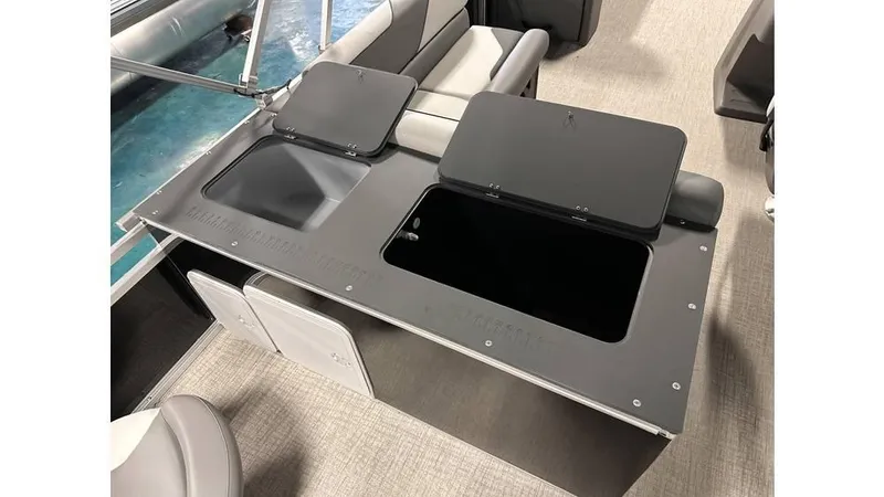 Slide: The Image of 2025 Tahoe Pontoon Sport 85 Rear Fish boat interior with storage compartments open. - 8
