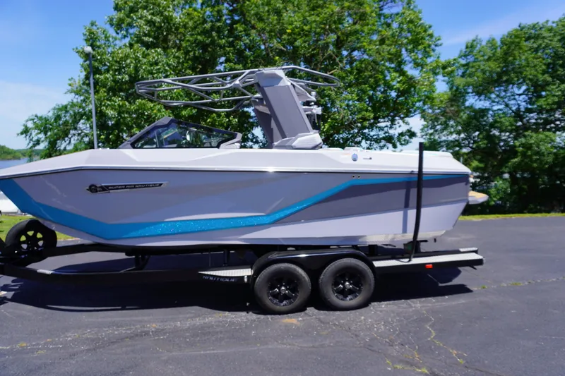 Slide: The Image of 2025 Nautique Super Air Nautique G21 boat on trailer, parked outdoors. - 1