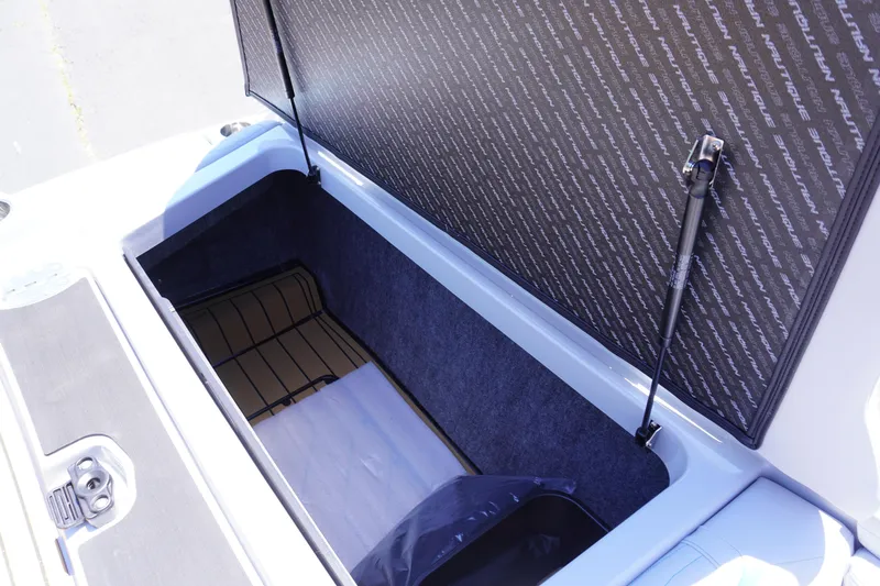 Slide: The Image of 2025 Nautique Super Air Nautique G21 storage compartment with open lid, showcasing spacious interior. - 14