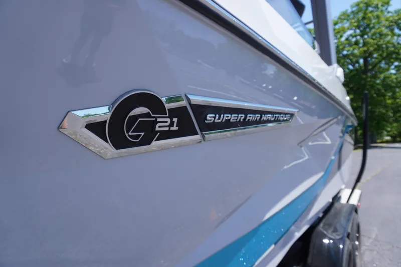 Slide: The Image of 2025 Nautique Super Air Nautique G21 boat emblem on sleek white hull. - 3