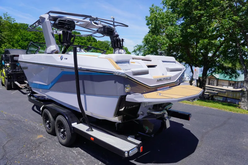 Slide: The Image of 2025 Nautique Super Air Nautique G21 boat on trailer, parked outdoors. - 4