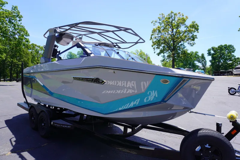 Slide: The Image of 2025 Nautique Super Air Nautique G21 boat on trailer, parked outdoors. - 6