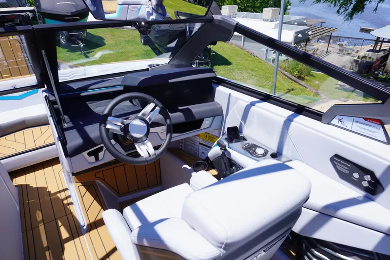 Slide: The Image of 2025 Nautique Super Air Nautique G21 boat interior with modern steering and controls. - 8