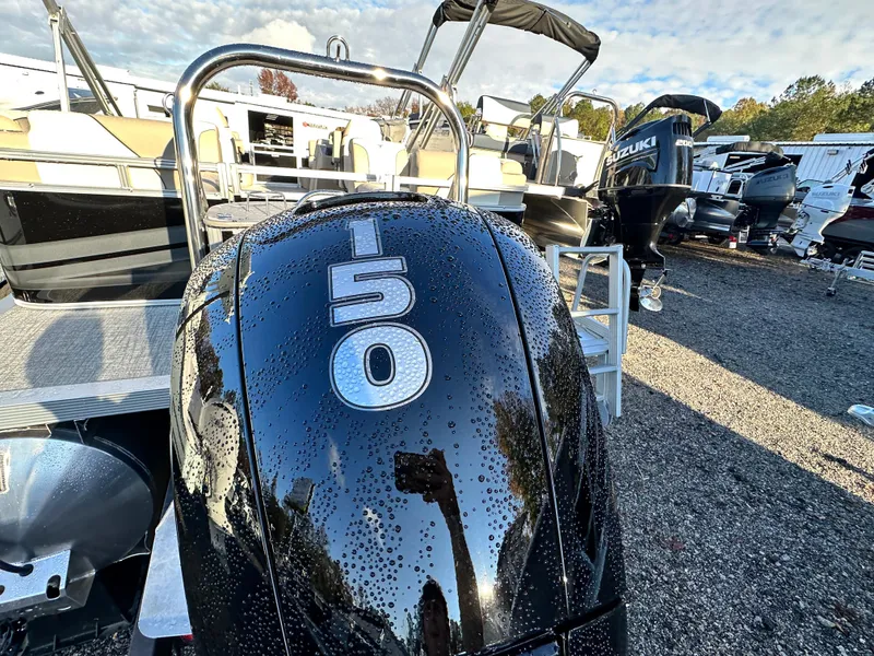 Slide: The Image of 2025 Tahoe Pontoon Sport 85 Quad Lounger with 150 HP engine, parked outdoors. - 10