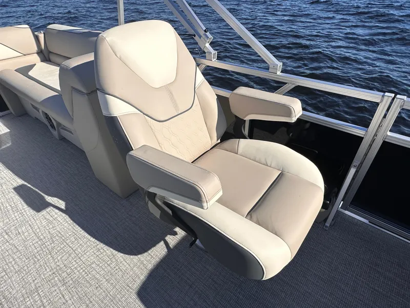 Slide: The Image of 2025 Tahoe Pontoon Sport 85 Quad Lounger with beige seating on a lake. - 5