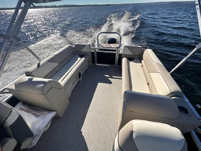 Slide: The Image of 2025 Tahoe Pontoon Sport 85 Quad Lounger cruising on a sunny lake. - 6