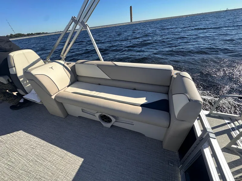 Slide: The Image of 2025 Tahoe Pontoon Sport 85 Quad Lounger on water, featuring comfortable seating and scenic view. - 7