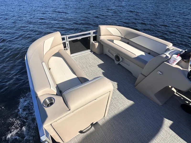 Slide: The Image of 2025 Tahoe Pontoon Sport 85 Quad Lounger on water, featuring spacious seating and modern design. - 8