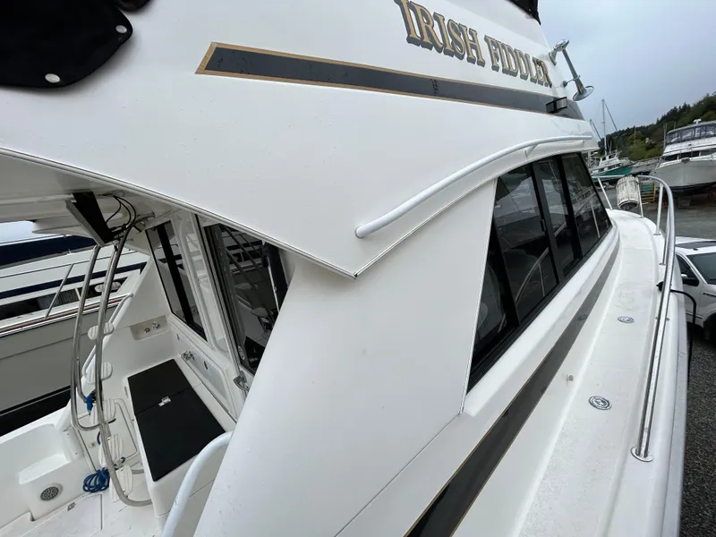 Slide: The Image of Riviera 34 Convertible yacht, 2000 model, docked with visible deck and cabin details. - 11