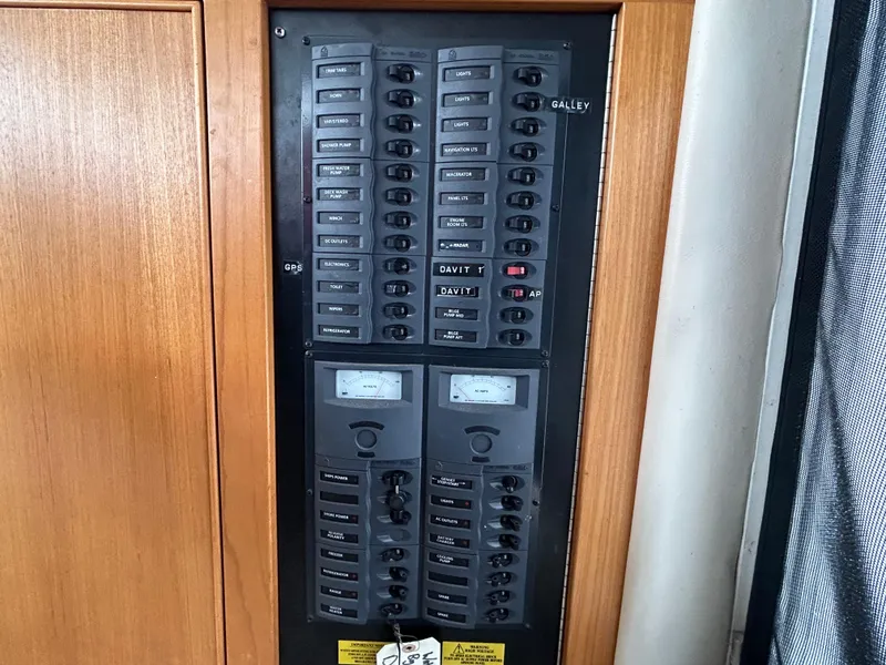 Slide: The Image of Electrical panel on a 2000 Riviera 34 Convertible boat, featuring multiple switches and meters. - 13