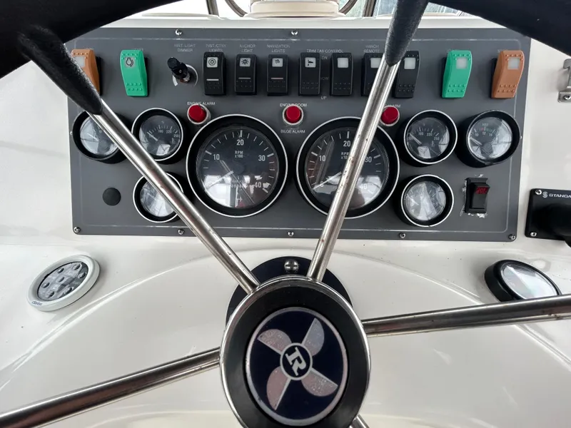 Slide: The Image of Control panel of a 2000 Riviera 34 Convertible boat with gauges and switches. - 17
