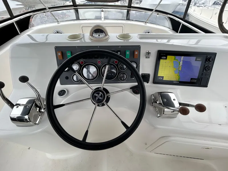 Slide: The Image of Cockpit of 2000 Riviera 34 Convertible with steering wheel and navigation system. - 18