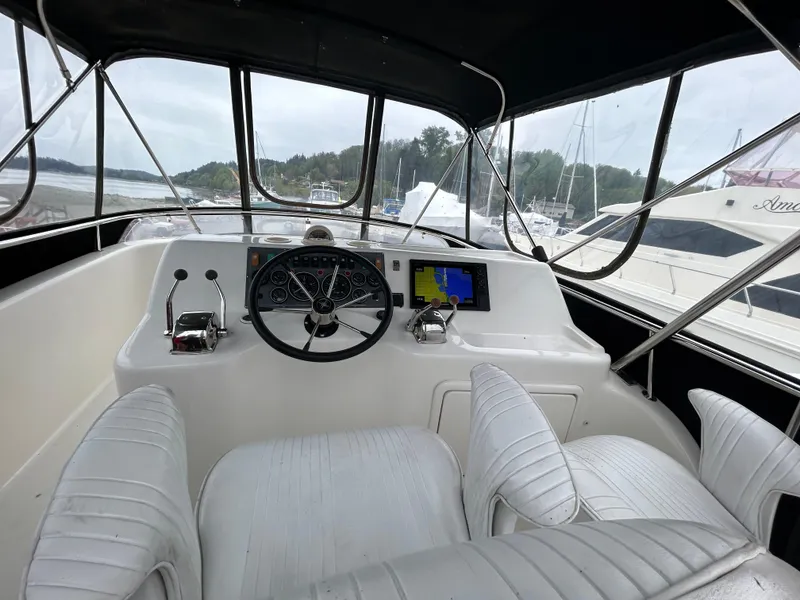 Slide: The Image of Helm of 2000 Riviera 34 Convertible yacht with steering wheel and navigation equipment. - 19