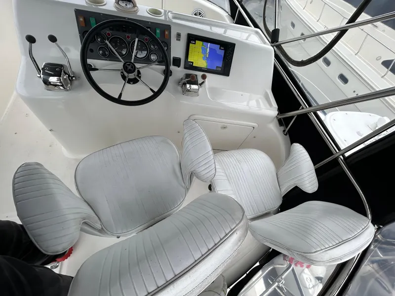 Slide: The Image of Helm of 2000 Riviera 34 Convertible with steering wheel, navigation screen, and cushioned seats. - 20