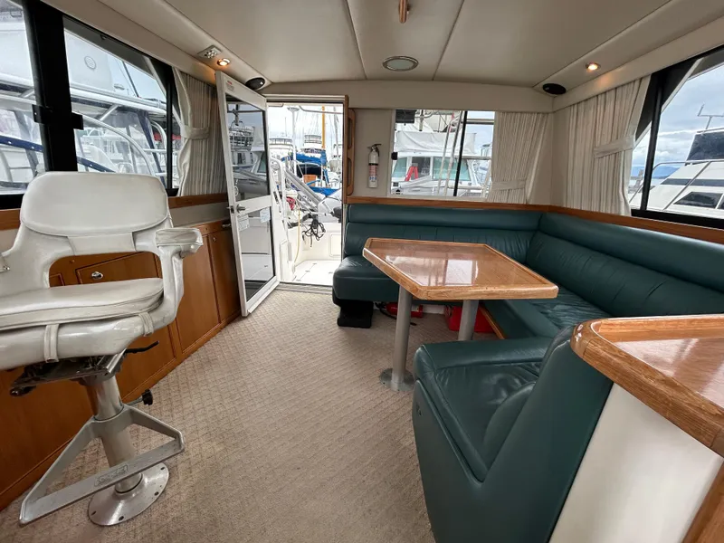 Slide: The Image of Interior of 2000 Riviera 34 Convertible yacht with seating and table. - 21