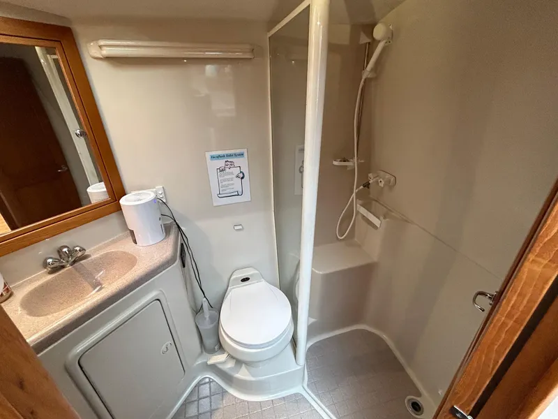 Slide: The Image of Bathroom interior of 2000 Riviera 34 Convertible yacht with shower and sink. - 23