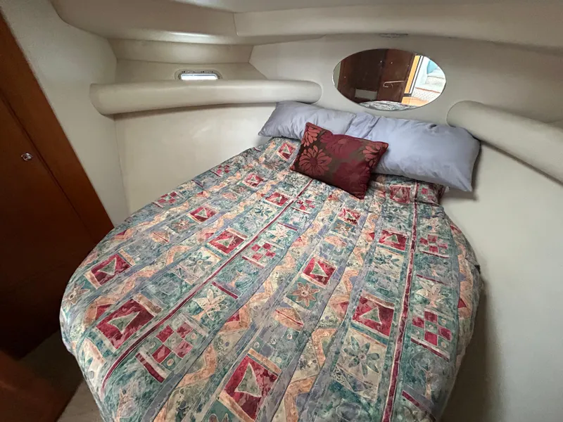 Slide: The Image of Cozy bedroom in 2000 Riviera 34 Convertible yacht with patterned bedding. - 26