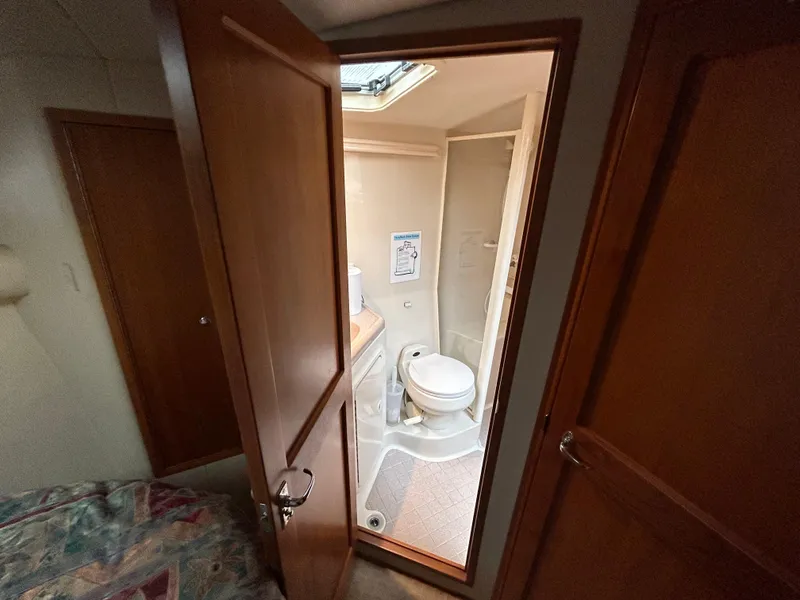 Slide: The Image of Interior view of a 2000 Riviera 34 Convertible yacht bathroom with shower and toilet. - 27