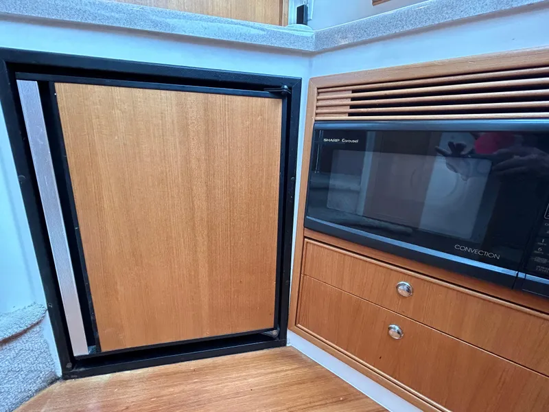 Slide: The Image of Interior of 2000 Riviera 34 Convertible with wood cabinetry and built-in microwave. - 30