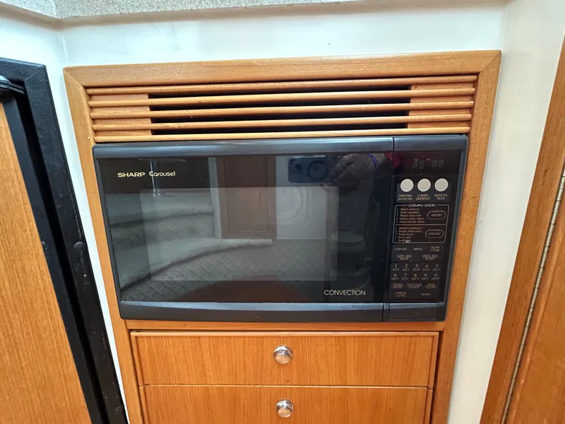 Slide: The Image of Built-in Sharp convection microwave in 2000 Riviera 34 Convertible yacht kitchen. - 31