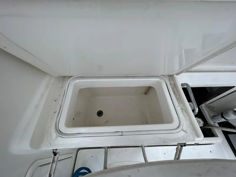 Slide: The Image of Open storage compartment on 2000 Riviera 34 Convertible boat deck. - 38