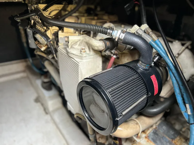 Slide: The Image of Engine compartment of a 2000 Riviera 34 Convertible boat, featuring detailed components and wiring. - 39