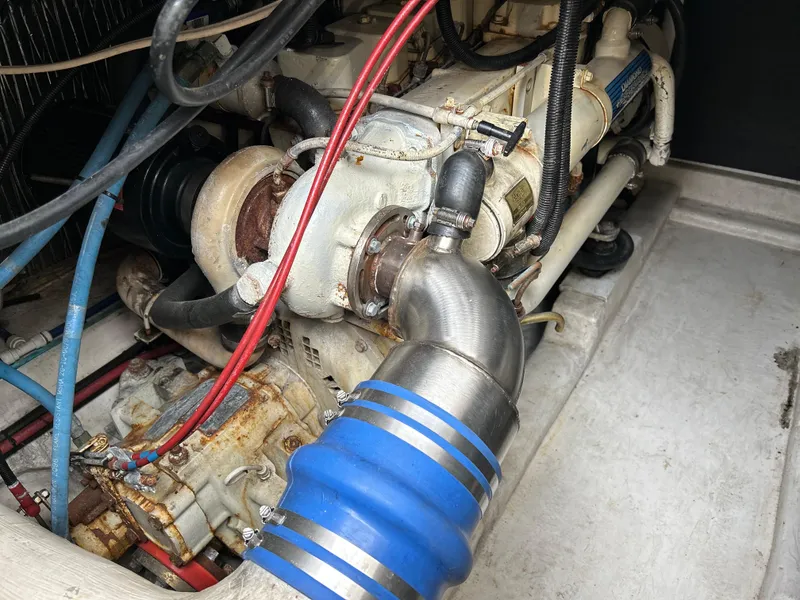Slide: The Image of Engine compartment of a 2000 Riviera 34 Convertible boat, featuring various hoses and components. - 40