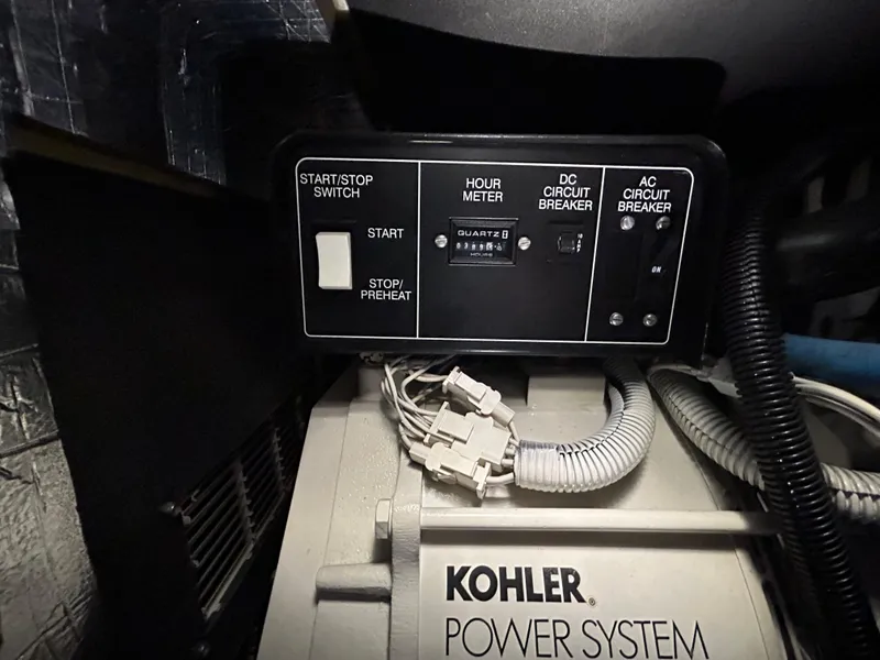 Slide: The Image of Kohler power system control panel with start/stop switch and circuit breakers on Riviera 34 Convertible. - 42