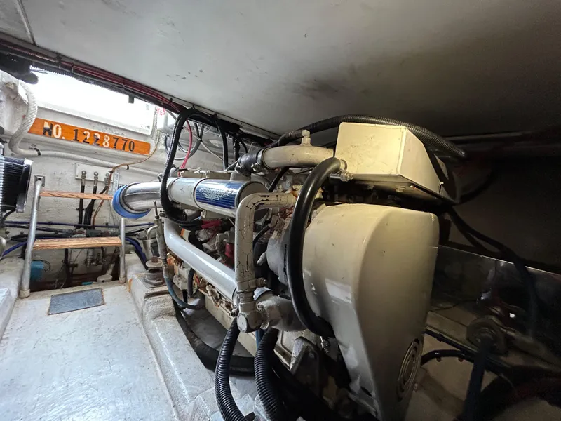 Slide: The Image of Engine room of 2000 Riviera 34 Convertible boat, showcasing mechanical components and wiring. - 45
