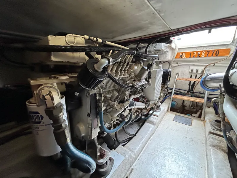 Slide: The Image of Engine room of a 2000 Riviera 34 Convertible boat, showcasing mechanical components. - 46