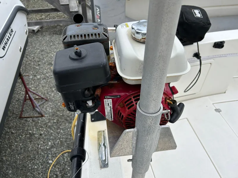 Slide: The Image of Boat engine on a 2000 Riviera 34 Convertible, docked with visible equipment. - 48