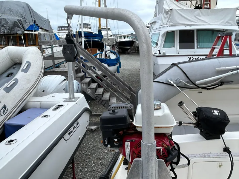 Slide: The Image of Boat docked with equipment, featuring a Riviera 34 Convertible, 2000 model, in a marina setting. - 49
