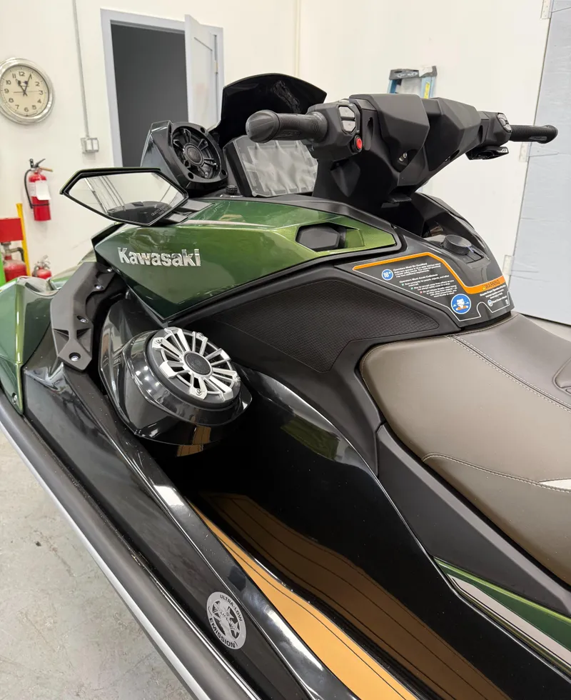 Slide: The Image of 2025 Kawasaki ULTRA 160 LX jet ski in a showroom, featuring sleek design and advanced controls. - 4
