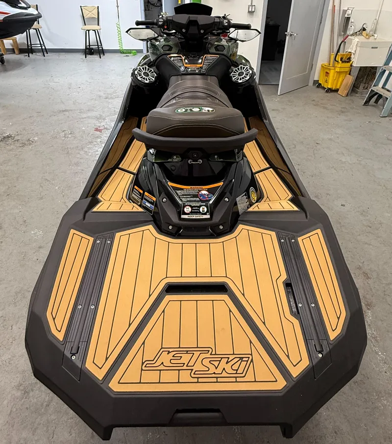 Slide: The Image of 2025 Kawasaki ULTRA 160 LX jet ski with sleek design and wood-textured deck in a garage setting. - 6