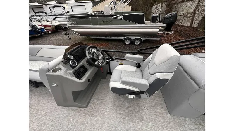 Slide: The Image of 2025 Tahoe Pontoon Sport 85 Quad Lounger interior with steering console and seating. - 3