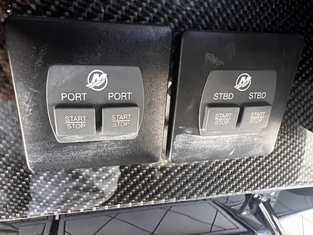 Slide: The Image of Control panel of 2022 Nor-Tech 390 Sport Center Console with start/stop buttons. - 10