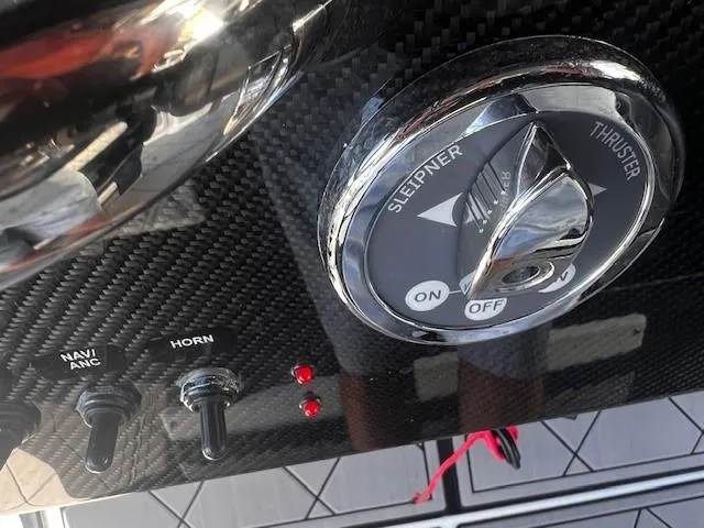 Slide: The Image of Control panel of 2022 Nor-Tech 390 Sport Center Console with switches and thruster dial. - 11