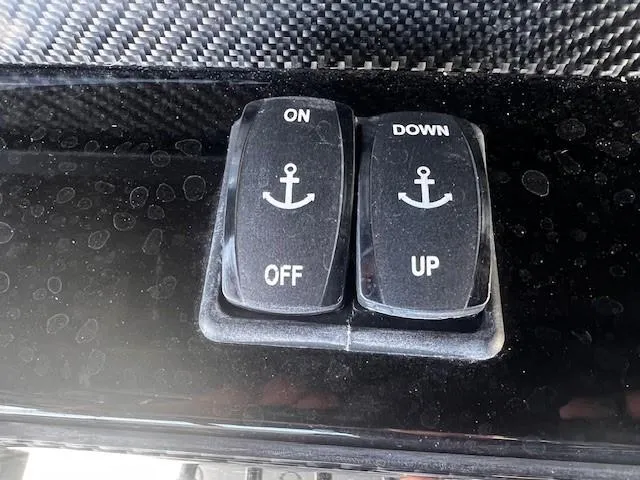Slide: The Image of Switches on a 2022 Nor-Tech 390 Sport Center Console boat dashboard. - 2