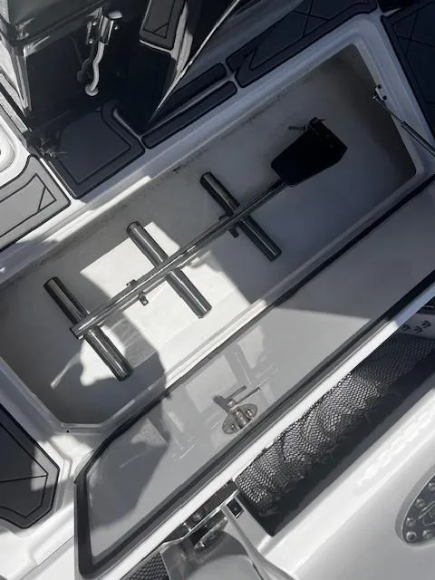 Slide: The Image of Open storage compartment in 2022 Nor-Tech 390 Sport Center Console boat. - 21