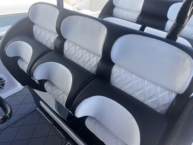 Slide: The Image of 2022 Nor-Tech 390 Sport Center Console boat seats with black and white diamond-pattern upholstery. - 24