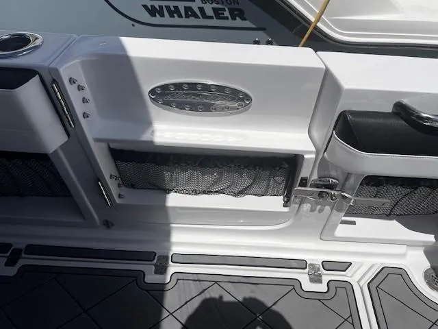 Slide: The Image of 2022 Nor-Tech 390 Sport Center Console boat deck with storage compartments and cup holders. - 27