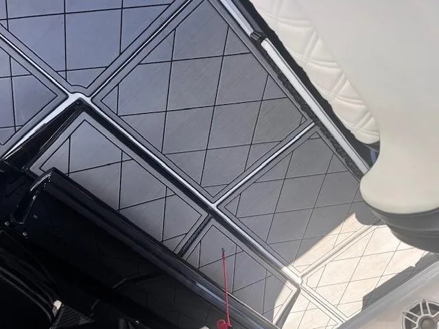 Slide: The Image of 2022 Nor-Tech 390 Sport Center Console boat interior with diamond-patterned flooring. - 29