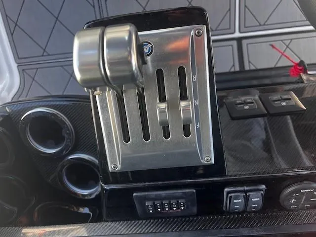 Slide: The Image of Throttle controls on a 2022 Nor-Tech 390 Sport Center Console boat dashboard. - 3
