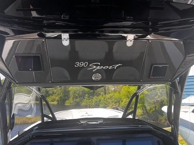 Slide: The Image of 2022 Nor-Tech 390 Sport Center Console boat interior with sleek black design and modern features. - 5
