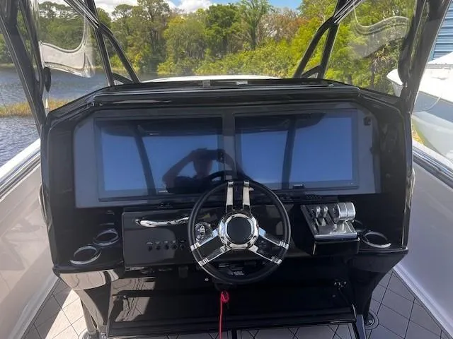 Slide: The Image of 2022 Nor-Tech 390 Sport Center Console dashboard with steering wheel and digital displays. - 6