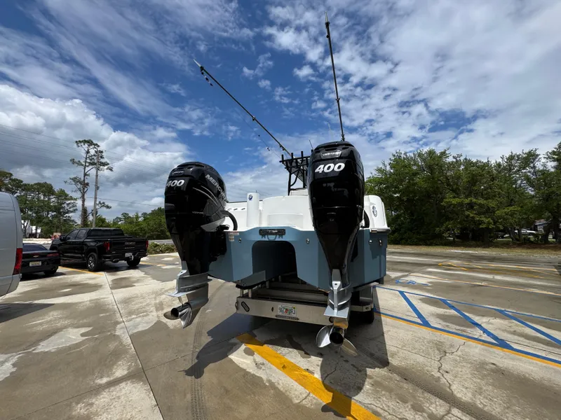 Slide: The Image of 2022 Invincible 33 Catamaran with twin 400 horsepower engines on a trailer. - 15