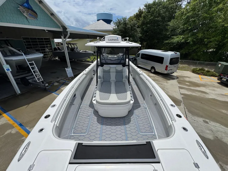 Slide: The Image of 2022 Invincible 33 Catamaran docked, showcasing spacious deck and modern design. - 20